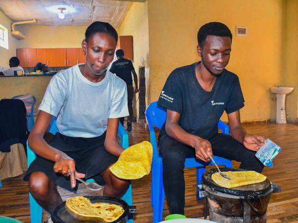 Members preparing food at Zion Children's Home Visit