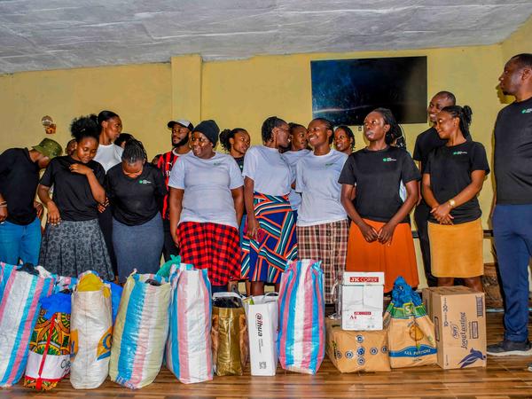 Members with donated items at Zion Children's Home Visit