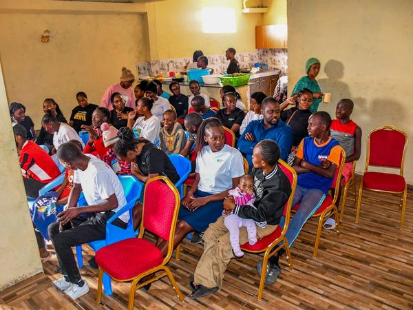 Members and children gathered in the hall at Zion Children's Home Visit