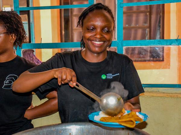 A member serving food at Zion Children's Home Visit