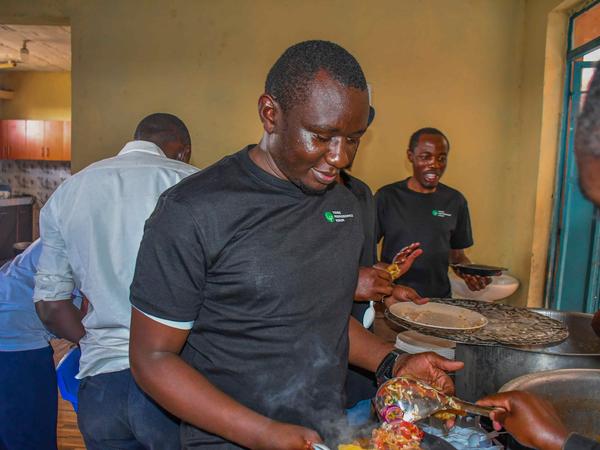 Members cooking together at Zion Children's Home Visit
