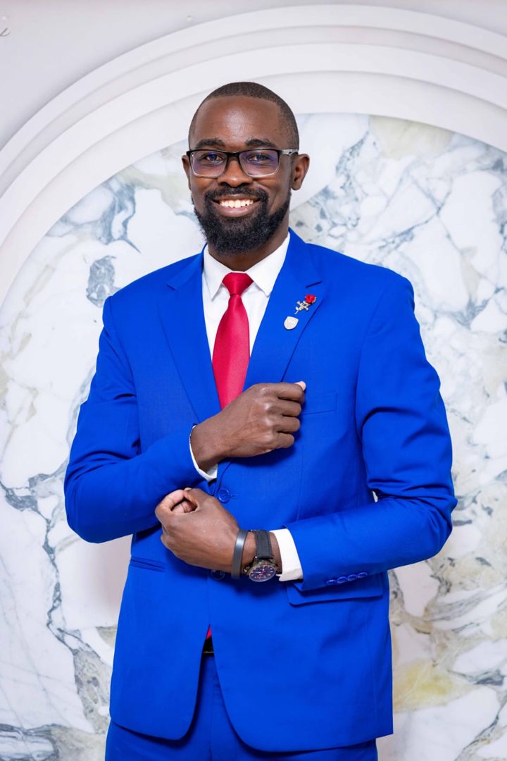 Dan Luvutse in a blue suit