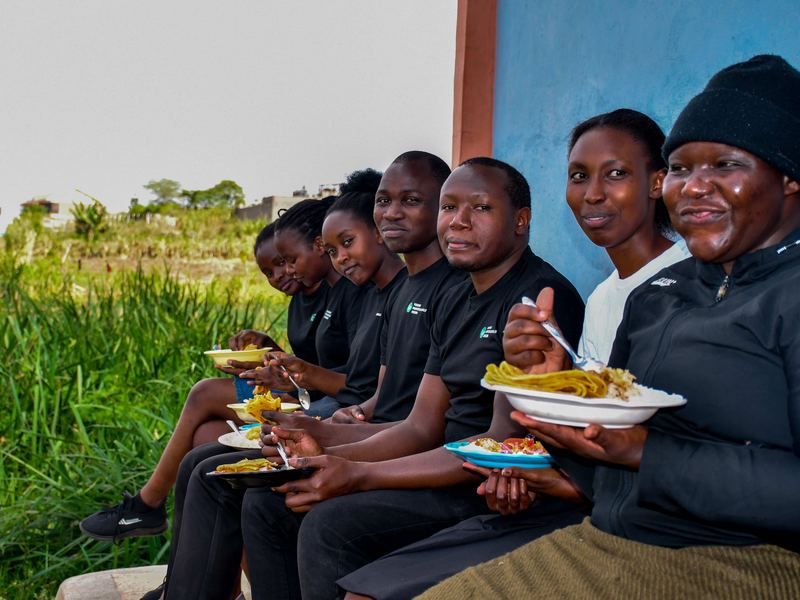 YPF members sharing a meal during the Zion Children's Home visit in Mwiki